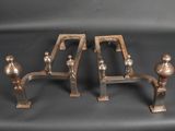 pair of antique brass candlesticks on a black background