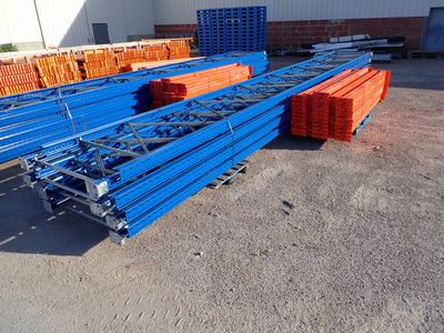 several stacks of blue and orange pallets in a warehouse yard