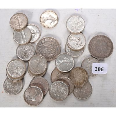 a lot of coins sitting on a table with a price tag
