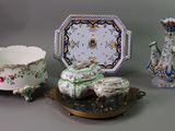 three different pieces of porcelain on display on a table
