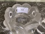 a glass bowl that is sitting on a marble table