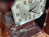 a clock that is sitting inside of a wooden box