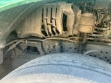 a close up view of the engine of a green truck