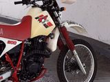 a red and white motorcycle parked in a garage