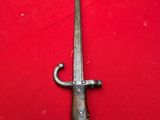 an old sword on a red table cloth