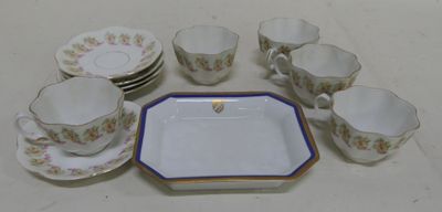 a lot of cups and saucers sitting on a table