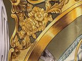 a close up of a gold crown on a green and white scarf