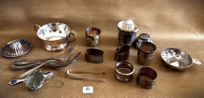 a lot of silverware on a table with a price tag