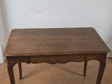 an old wooden table with a drawer underneath it on a tile floor