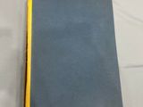 the book is blue and yellow on a white sheet