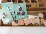 a wooden box filled with assorted buttons and buttons