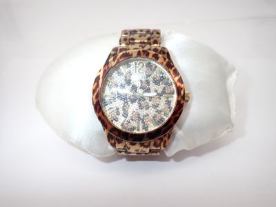 a watch that is sitting on top of a shell