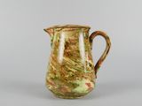 an image of a green and brown pitcher on a table