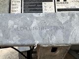 a close up of a metal bench with a sign on it