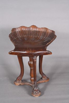 a small wooden table with a shell on it