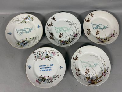 four porcelain plates with birds and flowers on them on a table