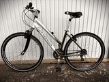 a bike parked against a wall in front of a building