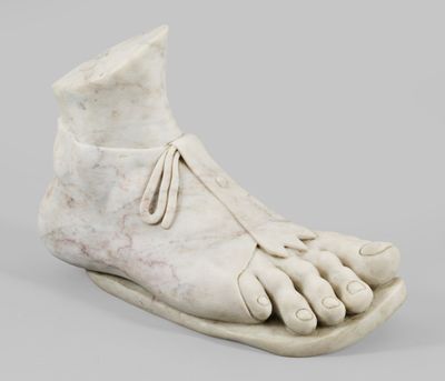 sculpture of a foot with a shoe on it ' s side