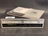 an image of a cassette player sitting on top of a stack of books