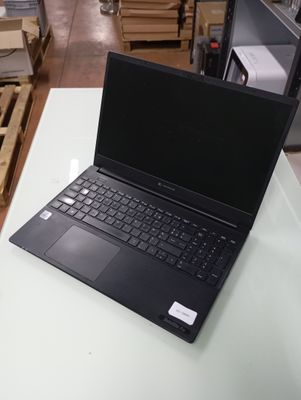 a laptop computer sitting on a table in a warehouse