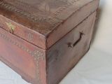 a small wooden box with a handle on a white surface