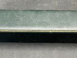 a small black box with a gold handle on a table