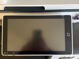a tablet that is sitting on top of a printer