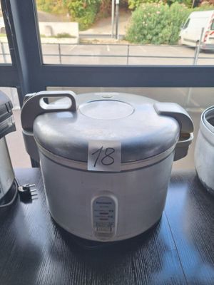 a silver crock pot sitting on a table next to a silver crock pot