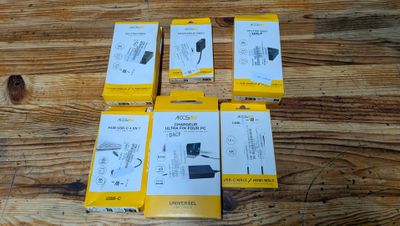 four boxes of nintendo wii controllers sitting on a wooden table
