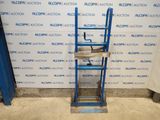 a blue ladder that is sitting in front of a wall