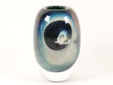 a glass vase with a black and blue design on it