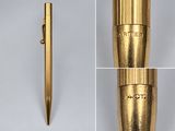 a close up of a gold pen with a metal cap