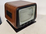 a small television sitting on top of a white table
