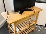 a television sitting on a wooden stand in the corner of a room
