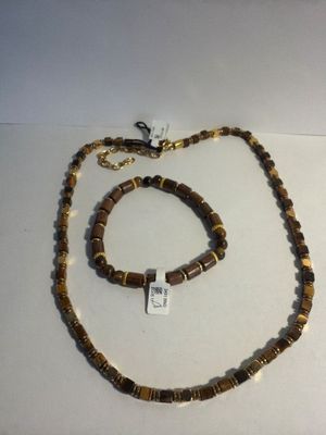 necklace and bracelet made of wood beads with a tag on a white surface