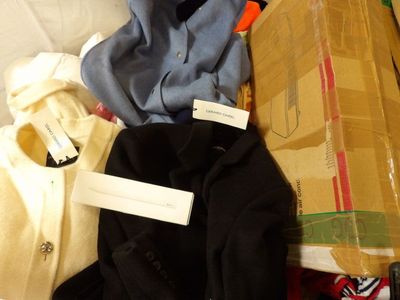 a pile of clothing that is sitting on a bed