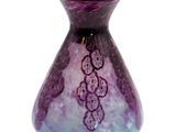 a purple and blue vase sitting on a white surface