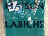 the polo shirt is wrapped in plastic with a name on it