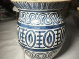 a blue and white vase sitting on a table
