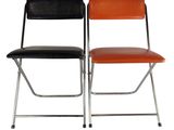 a pair of black and orange chairs sitting next to each other