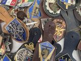 a lot of different types of badges on a table