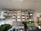 a room with a lot of boxes and containers on the shelves