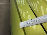 a measuring tape on the front of a green car