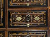 a wooden chest of drawers with many drawers on top of it