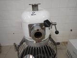 a white mixer sitting on top of a kitchen counter