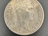 a silver coin with a woman ' s head on it