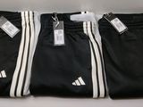 three pairs of black and white adidas pants with tags on them