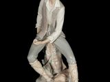 a figurine of a man sitting on a rock