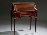 an antique writing desk with a wooden top and brass trimmings