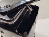 a black and silver toaster sitting on top of a white table